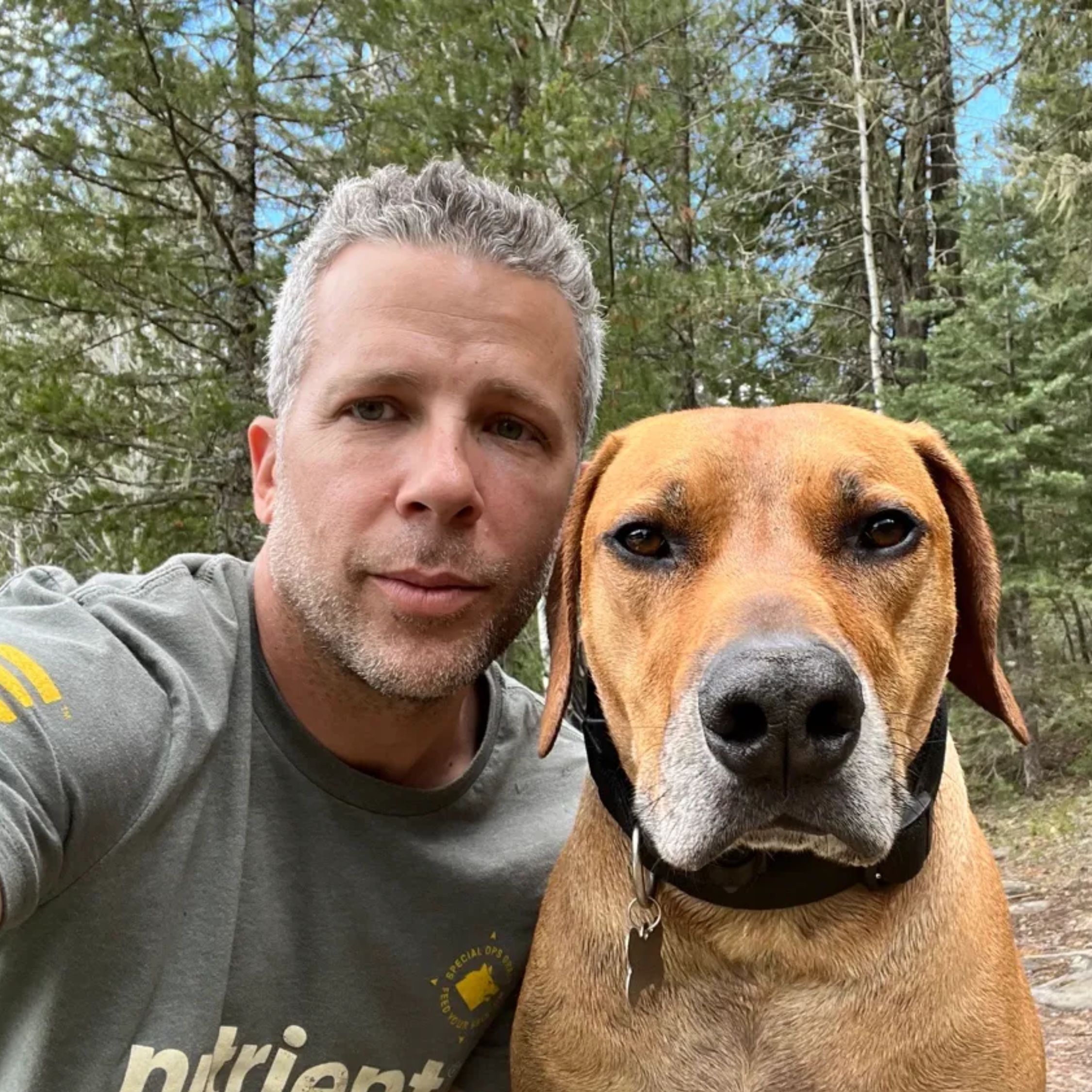 Justin, Owner & Developer of MyOunces, with his dog on a hiking trail
